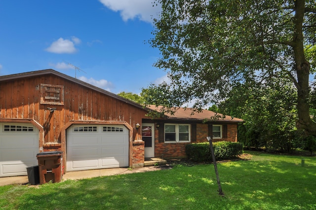 3847 Drew Rd, Arcanum, OH 45304 - view of front of house featuring a garage, a front lawn, and brick siding
