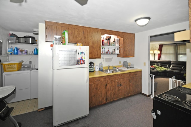 3847 Drew Rd, Arcanum, OH 45304 - kitchen featuring freestanding refrigerator, washer and dryer, black electric range oven, brown cabinetry, and light countertops