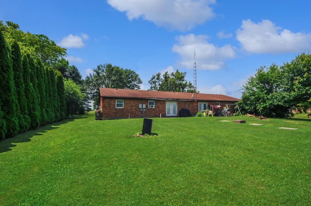 3847 Drew Rd, Arcanum, OH 45304 - back of house with a yard and brick siding
