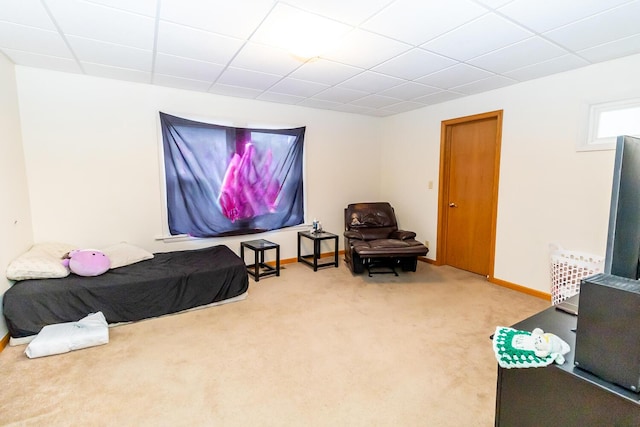 bedroom with carpet and a paneled ceiling