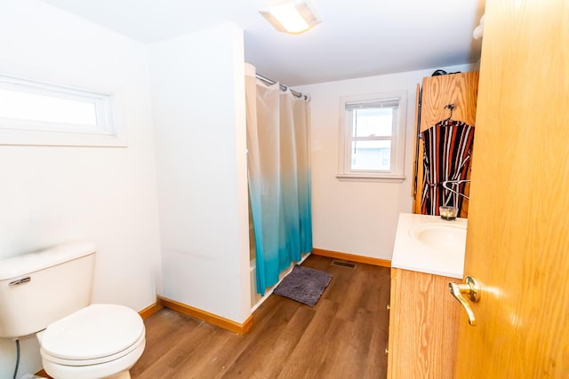 bathroom with hardwood / wood-style flooring, vanity, toilet, and a shower with shower curtain