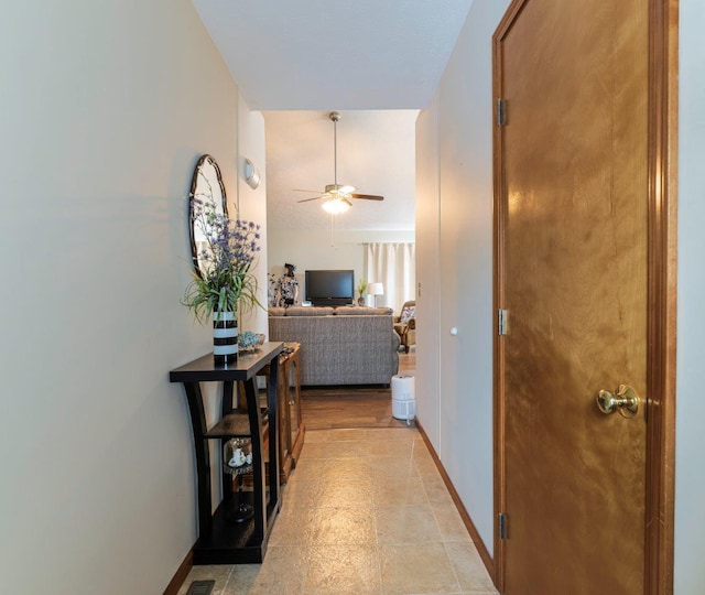 hallway featuring baseboards