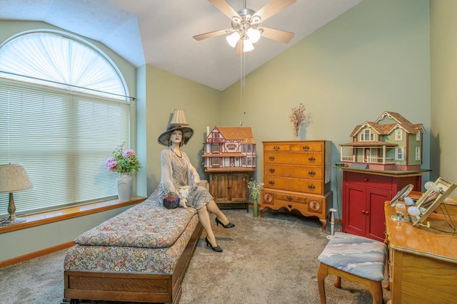 living area with lofted ceiling, ceiling fan, baseboards, and light colored carpet