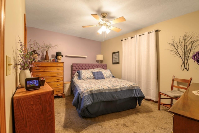 bedroom featuring ceiling fan, a textured ceiling, and carpet