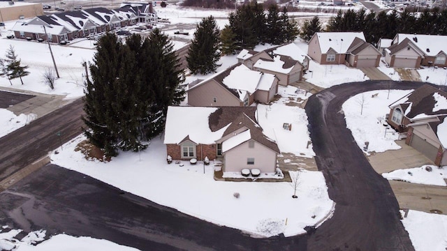 snowy aerial view with a residential view