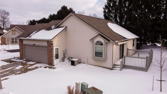 exterior space featuring a garage and brick siding