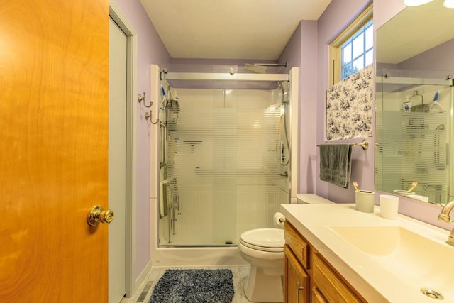 full bath with toilet, a shower stall, and vanity