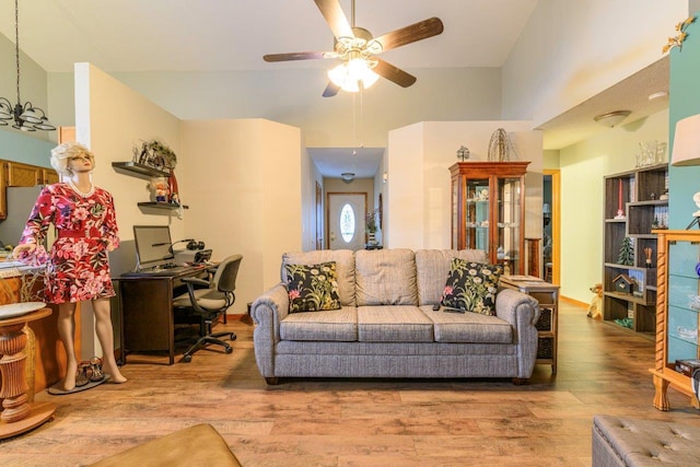 living area with a ceiling fan and wood finished floors