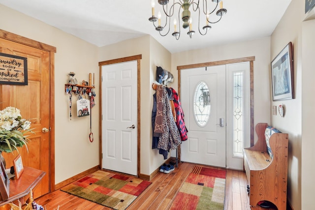 foyer entrance featuring an inviting chandelier and light hardwood / wood-style floors