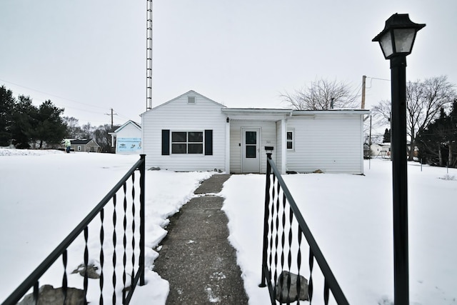 bungalow-style home with fence