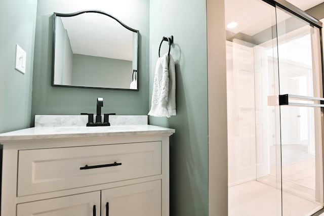 bathroom with a stall shower and vanity