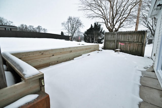 yard layered in snow with fence