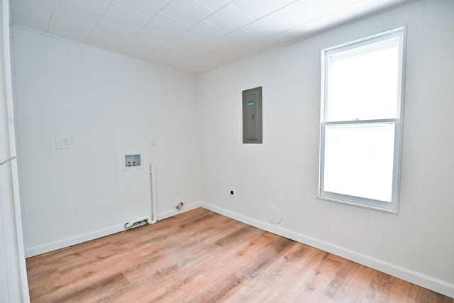 clothes washing area with hookup for a washing machine, wood finished floors, hookup for an electric dryer, electric panel, and hookup for a gas dryer