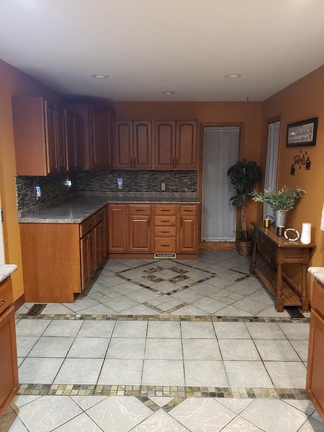 1607 Nagel St, Saint Marys, OH 45885 - kitchen featuring brown cabinets, tasteful backsplash, and light tile patterned floors
