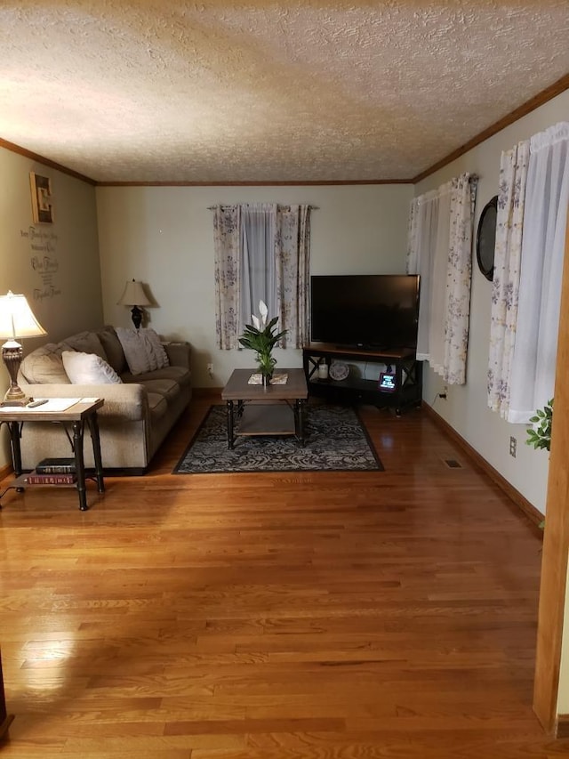 1607 Nagel St, Saint Marys, OH 45885 - living area with baseboards, wood finished floors, ornamental molding, and a textured ceiling