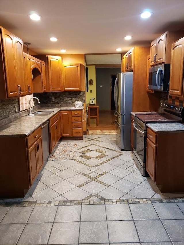 1607 Nagel St, Saint Marys, OH 45885 - kitchen featuring recessed lighting, decorative backsplash, a sink, dark countertops, and appliances with stainless steel finishes