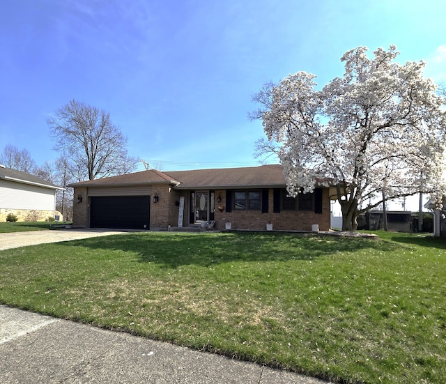 1607 Nagel St, Saint Marys, OH 45885 - single story home with brick siding, a garage, concrete driveway, and a front yard