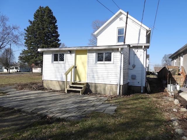 back of property featuring entry steps