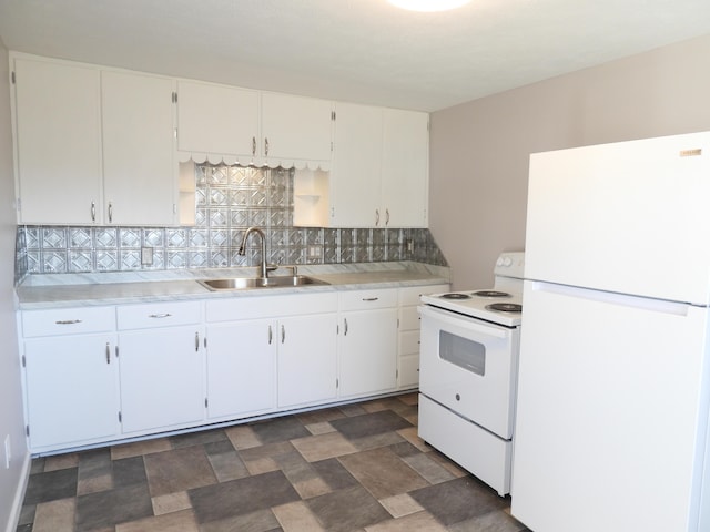 kitchen with white appliances, a sink, light countertops, white cabinets, and backsplash