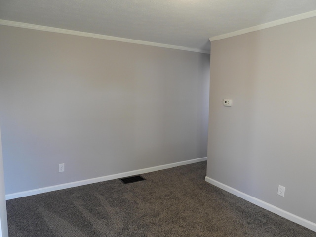 unfurnished room featuring visible vents, dark carpet, baseboards, and ornamental molding