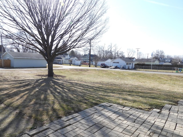 view of yard featuring fence and a residential view