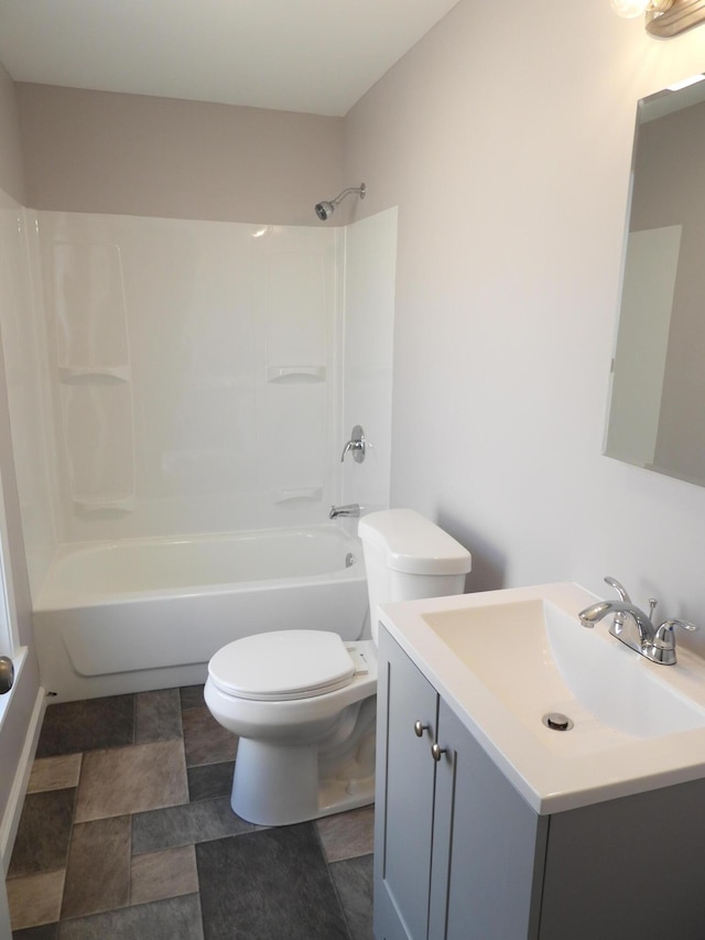 bathroom featuring vanity, toilet, and washtub / shower combination