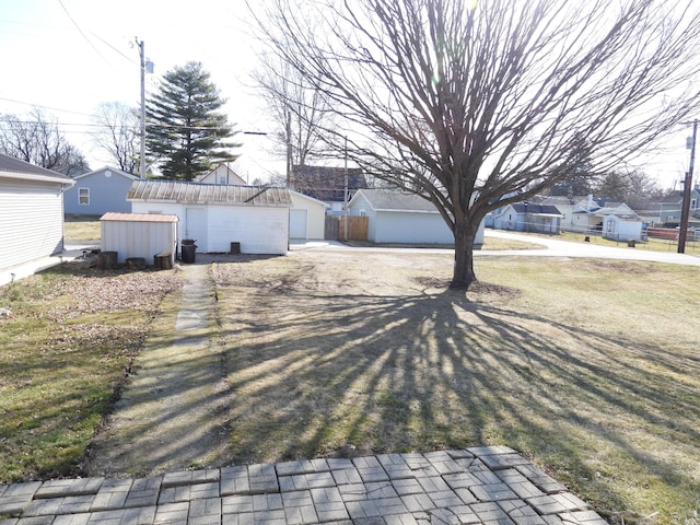 view of yard with an outbuilding and a detached garage