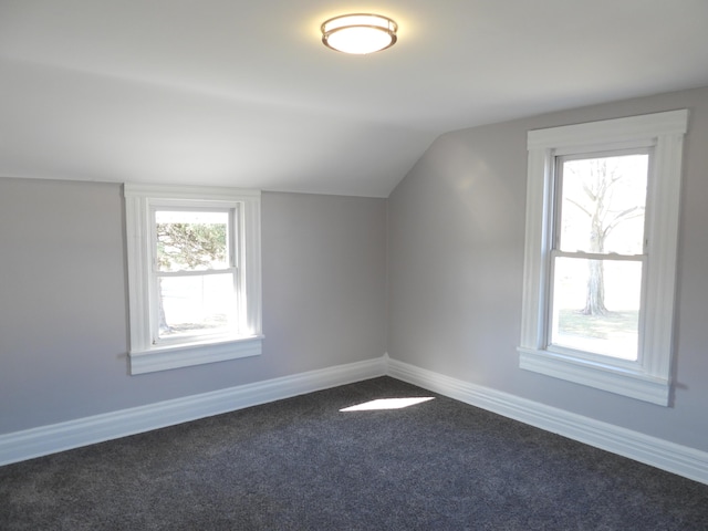 bonus room with lofted ceiling, baseboards, and carpet floors