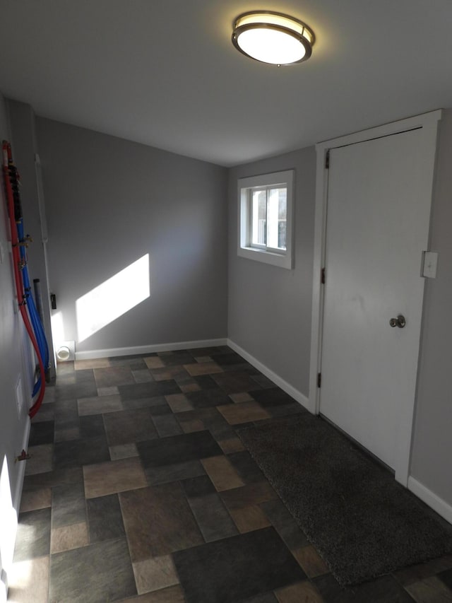 spare room with baseboards