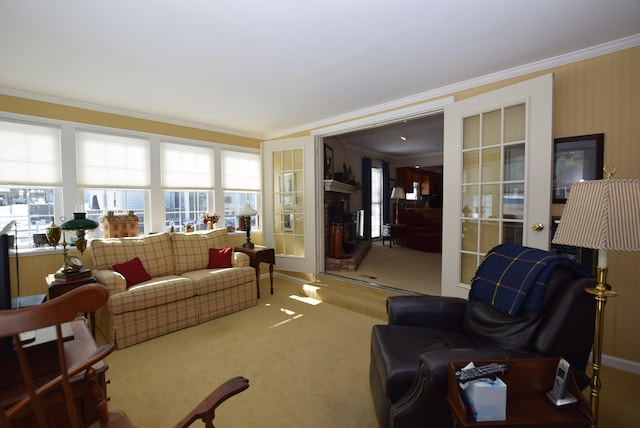 carpeted living room with ornamental molding and a fireplace