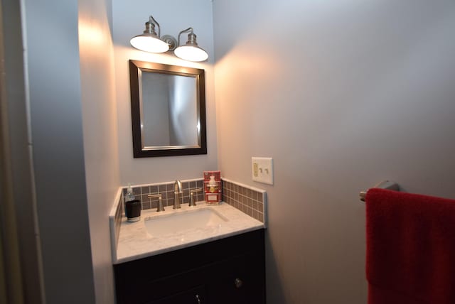 bathroom featuring tasteful backsplash and vanity