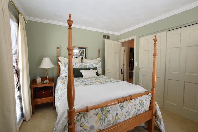 bedroom featuring ornamental molding, a closet, and carpet flooring