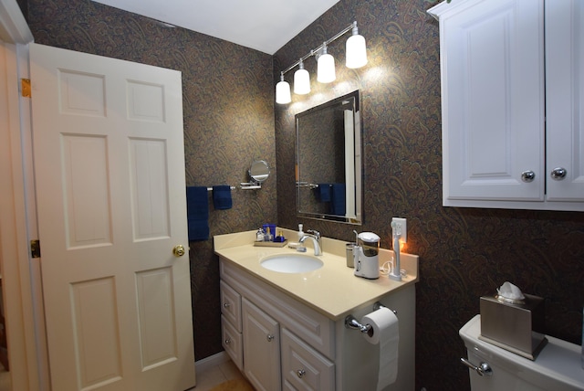 bathroom featuring vanity and toilet