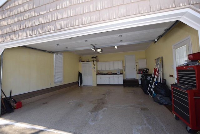 garage featuring a garage door opener and a workshop area