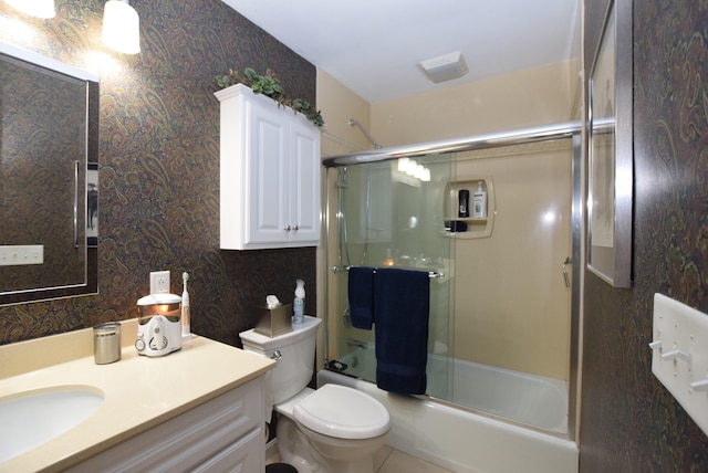 full bathroom featuring vanity, shower / bath combination with glass door, and toilet