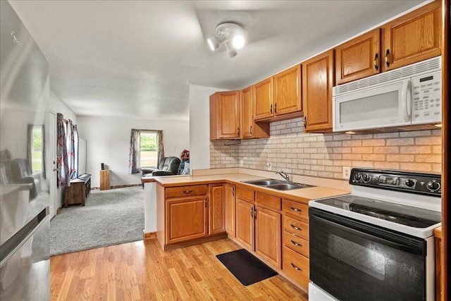 230 Morse St, Russells Point, OH 43348 - kitchen with range with electric stovetop, white microwave, a sink, open floor plan, and light countertops