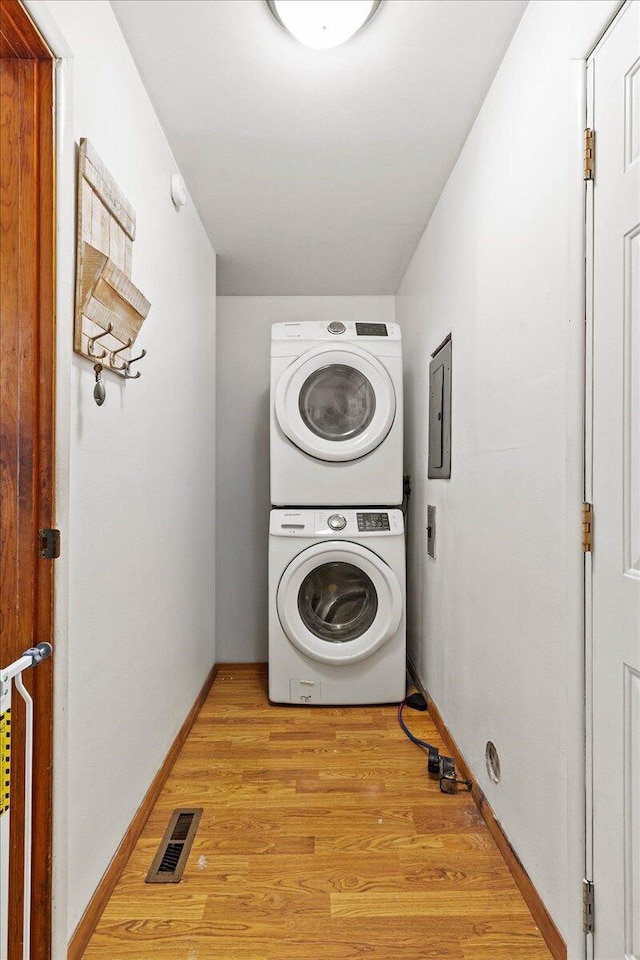 230 Morse St, Russells Point, OH 43348 - washroom with stacked washer / drying machine, light wood-style floors, baseboards, and electric panel