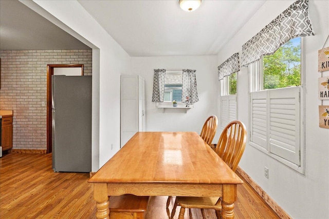 230 Morse St, Russells Point, OH 43348 - dining area with wood finished floors and brick wall