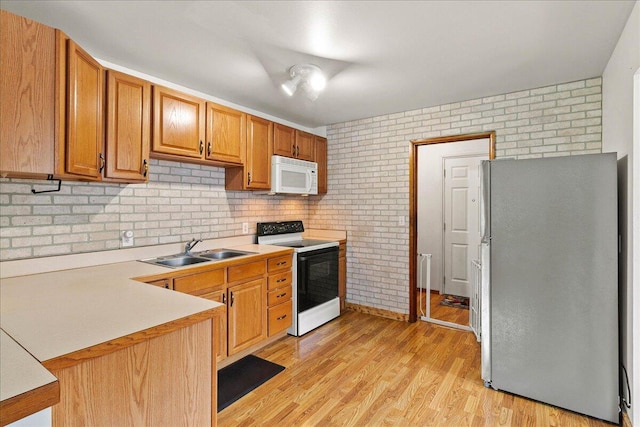 230 Morse St, Russells Point, OH 43348 - kitchen with freestanding refrigerator, electric range, white microwave, a sink, and light countertops