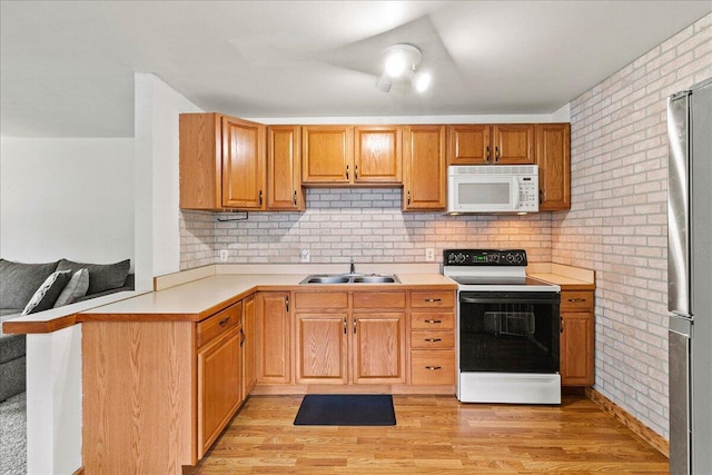230 Morse St, Russells Point, OH 43348 - kitchen featuring white microwave, range with electric cooktop, a sink, light countertops, and refrigerator