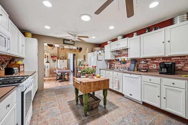 4711 N Elm Tree Rd, Conover, OH 45317 - kitchen featuring white appliances, ceiling fan, tasteful backsplash, white cabinetry, and light stone finish flooring