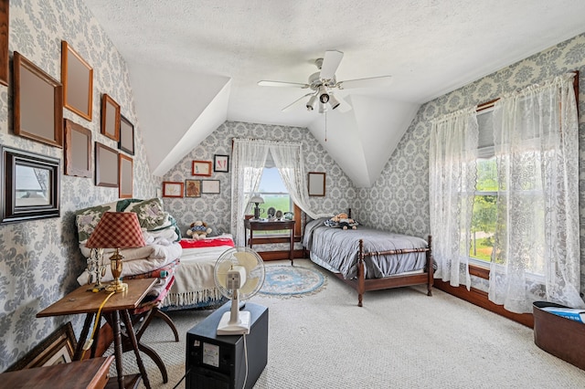 4711 N Elm Tree Rd, Conover, OH 45317 - bedroom with wallpapered walls, lofted ceiling, carpet floors, a textured ceiling, and ceiling fan