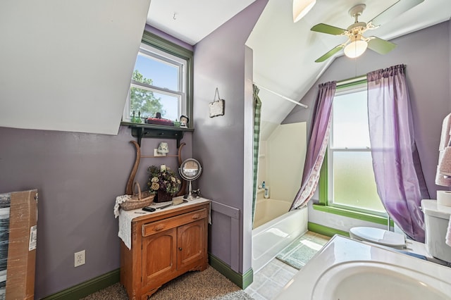 4711 N Elm Tree Rd, Conover, OH 45317 - bathroom featuring lofted ceiling, shower / bathtub combination with curtain, ceiling fan, and vanity