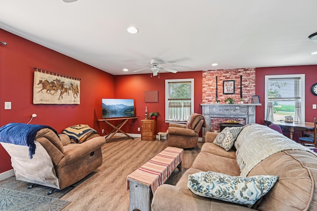 4711 N Elm Tree Rd, Conover, OH 45317 - living area with healthy amount of natural light, a brick fireplace, recessed lighting, a ceiling fan, and wood finished floors