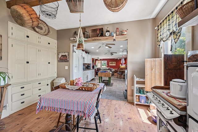4711 N Elm Tree Rd, Conover, OH 45317 - dining room with light wood finished floors and a ceiling fan