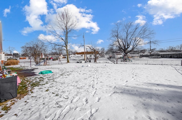 snowy yard with a playground