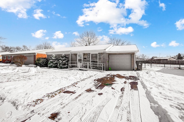 single story home featuring a garage and covered porch