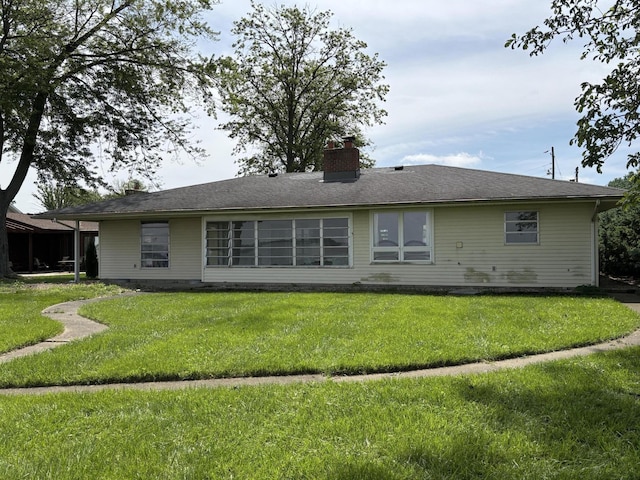 10081 Forest St, Lakeview, OH 43331 - rear view of house with a lawn and a chimney