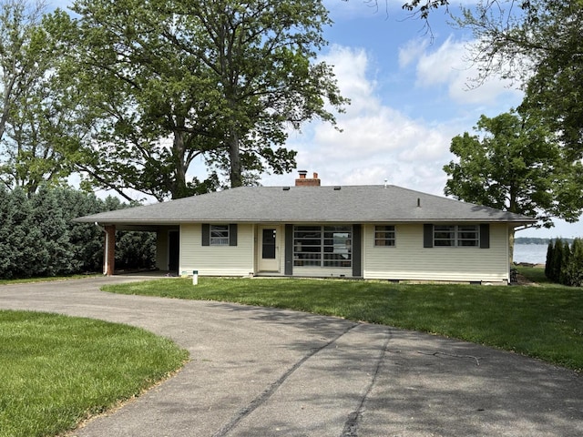 10081 Forest St, Lakeview, OH 43331 - ranch-style home featuring a chimney, driveway, a front yard, and a carport