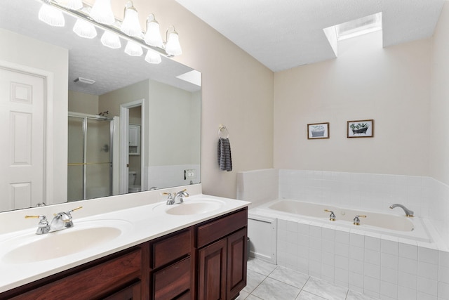 170 Fox Harbor Dr, Troy, OH 45373 - bathroom featuring a shower stall, a garden tub, double vanity, tile patterned floors, and a skylight